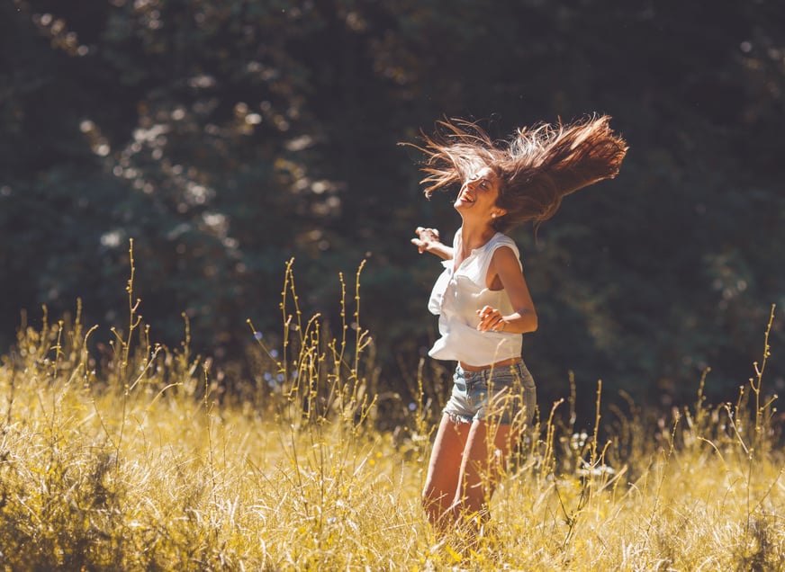 Attractive happy woman in nature.